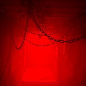 a red light is shining in a dark room