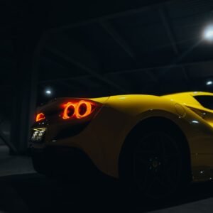 a yellow sports car parked in a parking garage