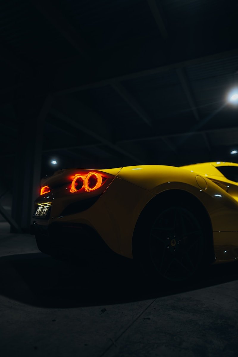 a yellow sports car parked in a parking garage