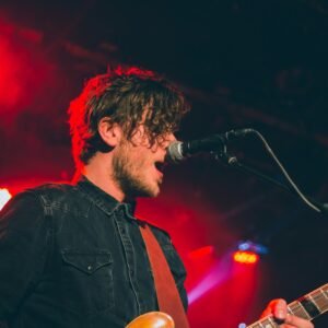 man playing guitar while singing